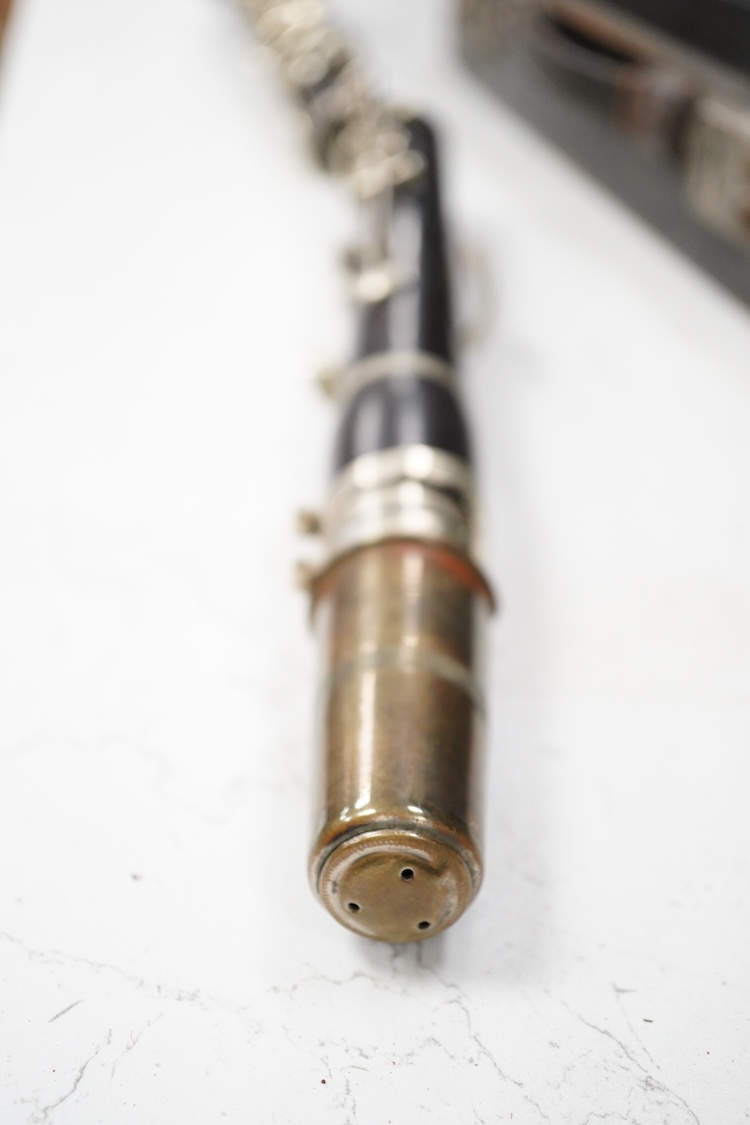 An early 20th century wooden Boosey and Hawkes clarinet in a fitted leather case